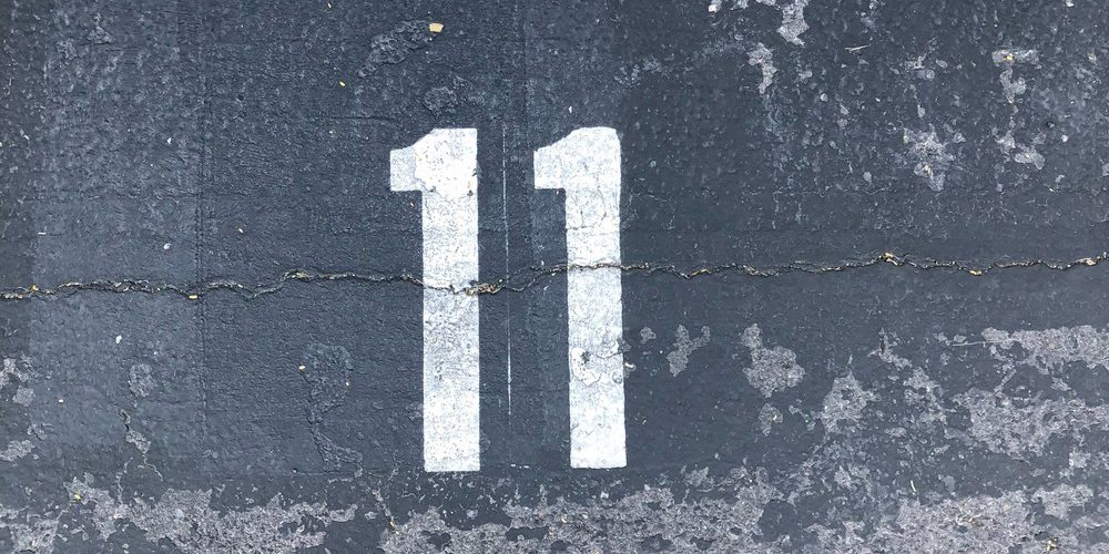 person-standing-on-concrete-floor-with-number-11-paint-1655998